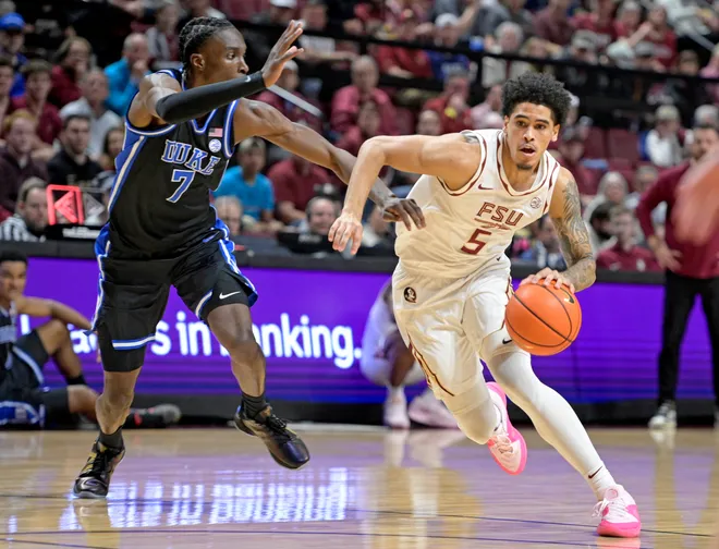 Jan 3, 2026; Tallahassee, Florida, USA; Florida State Seminoles guard Kobe MaGee (5) drives to the net past Duke Blue Devils guard Dame Sarr (7) during the first half at Donald L. Tucker Center. Mandatory Credit: Melina Myers-Imagn Images
