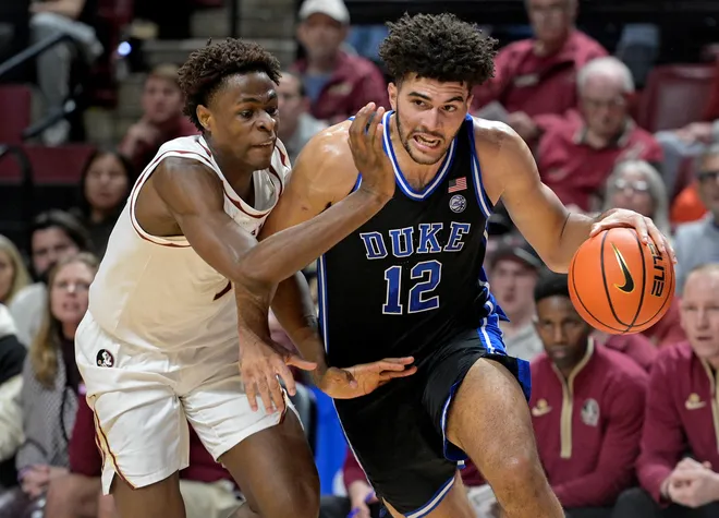 Jan 3, 2026; Tallahassee, Florida, USA; Duke Blue Devils forward Cameron Boozer (12) drives to the net past Florida State Seminoles forward Thomas Bassong (3) during the first half at Donald L. Tucker Center. Mandatory Credit: Melina Myers-Imagn Images