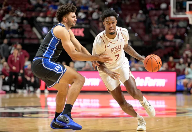 Jan 3, 2026; Tallahassee, Florida, USA; Duke Blue Devils forward Cameron Boozer (12) defends Florida State Seminoles forward Chauncey Wiggins (7) during the first half at Donald L. Tucker Center. Mandatory Credit: Melina Myers-Imagn Images
