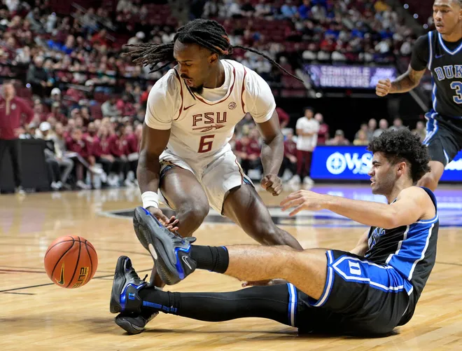 Jan 3, 2026; Tallahassee, Florida, USA; Duke Blue Devils guard Cayden Boozer (2) has the ball knocked away by Florida State Seminoles guard Robert McCray (6) during the first half at Donald L. Tucker Center. Mandatory Credit: Melina Myers-Imagn Images