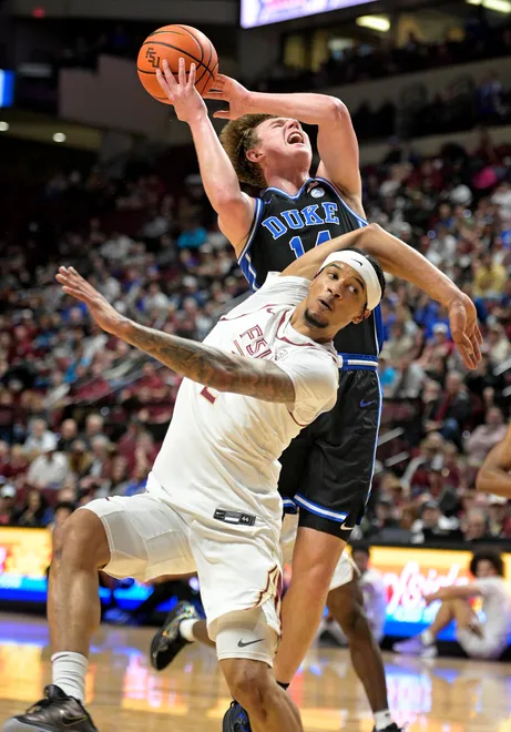 Jan 3, 2026; Tallahassee, Florida, USA; Duke Blue Devils guard Nikolas Khamenia (14) shoots past Florida State Seminoles guard Cam Miles (2) during the first half at Donald L. Tucker Center. Mandatory Credit: Melina Myers-Imagn Images