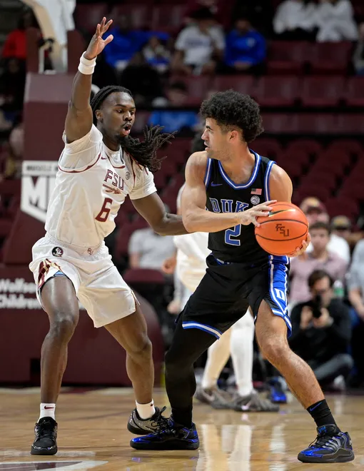 Jan 3, 2026; Tallahassee, Florida, USA; Duke Blue Devils guard Cayden Boozer (2) looks to pass the ball as he is defended by Florida State Seminoles guard Robert McCray (6) during the first half at Donald L. Tucker Center. Mandatory Credit: Melina Myers-Imagn Images