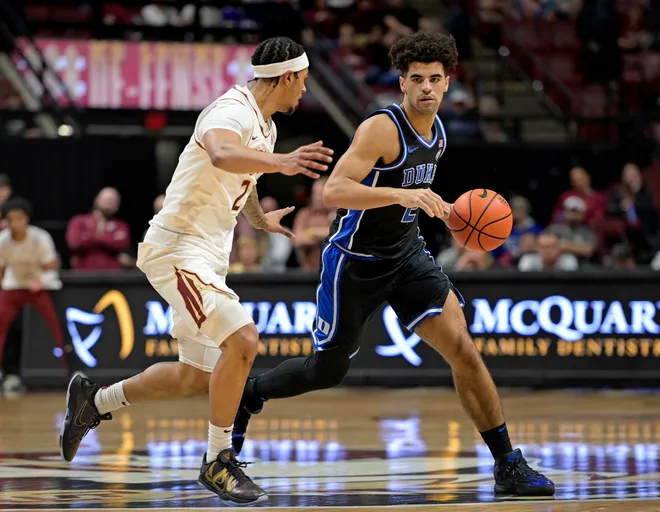 Jan 3, 2026; Tallahassee, Florida, USA; Duke Blue Devils guard Cayden Boozer (2) looks to pass the ball as he is defended by Florida State Seminoles guard Cam Miles (2) during the second half at Donald L. Tucker Center. Mandatory Credit: Melina Myers-Imagn Images