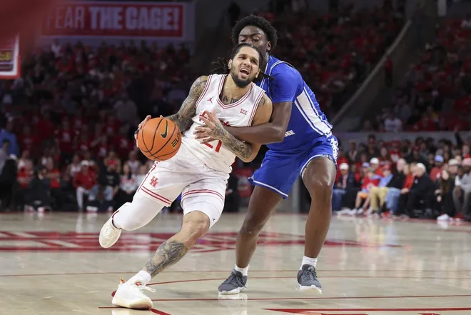 Dec 29, 2025; Houston, Texas, USA; Houston Cougars guard Emanuel Sharp (21) drives with the ball as Middle Tennessee Blue Raiders guard Kamari Lands (22) defends during the second half at Fertitta Center.