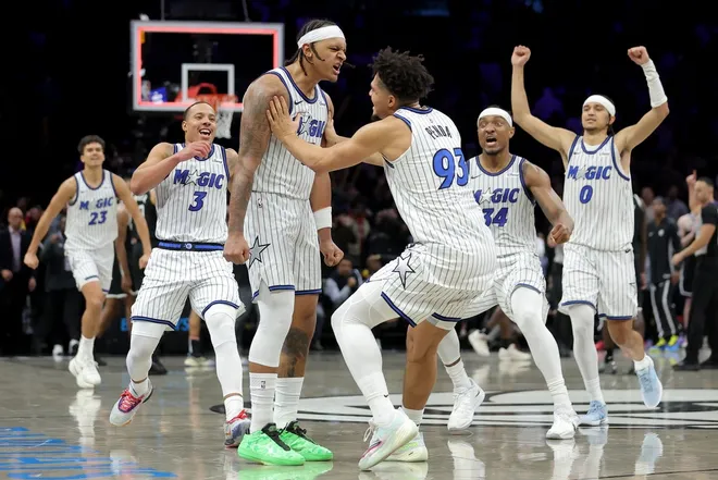 Jan 7, 2026; Brooklyn, New York, USA; Orlando Magic forward Paolo Banchero (5) celebrates his overtime game-winning three point shot against the Brooklyn Nets with guard Desmond Bane (3) and forward Noah Penda (93) and center Wendell Carter Jr. (34) and guard Anthony Black (0) at Barclays Center.