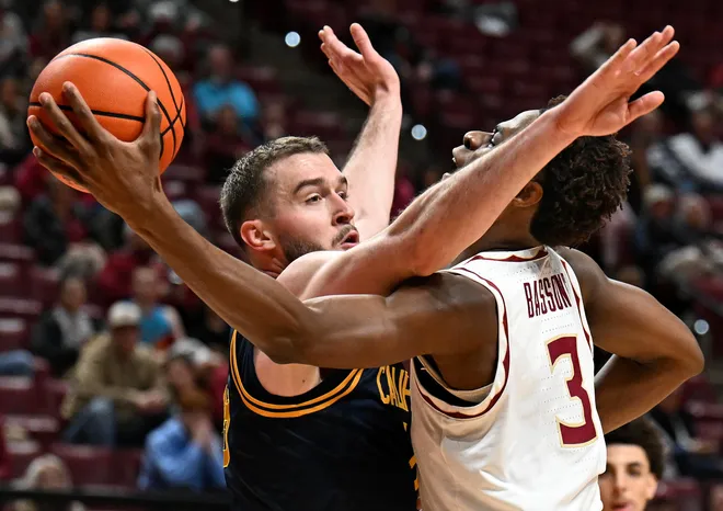 Jan 28, 2026; Tallahassee, Florida, USA; Florida State Seminoles forward Thomas Bassong (3) shoots the ball past California Golden Bears center Milos Ilic (8) during the first half at Donald L. Tucker Center. Mandatory Credit: Melina Myers-Imagn Images