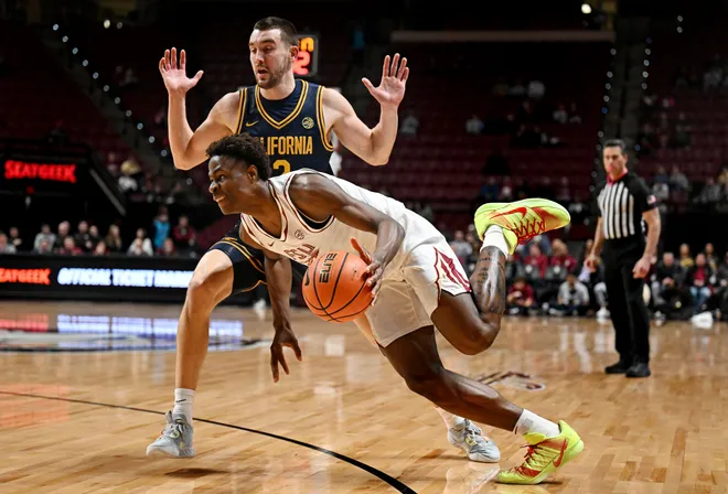 Jan 28, 2026; Tallahassee, Florida, USA; Florida State Seminoles forward Thomas Bassong (3) drives to the net past the defense of California Golden Bears forward John Camden (2) during the first half at Donald L. Tucker Center. Mandatory Credit: Melina Myers-Imagn Images