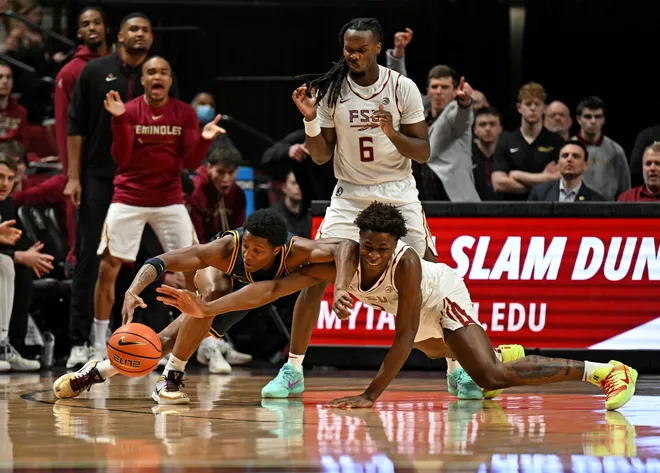 Jan 28, 2026; Tallahassee, Florida, USA; California Golden Bears Dai Dai Ames (7) fights for a loose ball against Florida State Seminoles forward Thomas Bassong (3) during the first half at Donald L. Tucker Center. Mandatory Credit: Melina Myers-Imagn Images