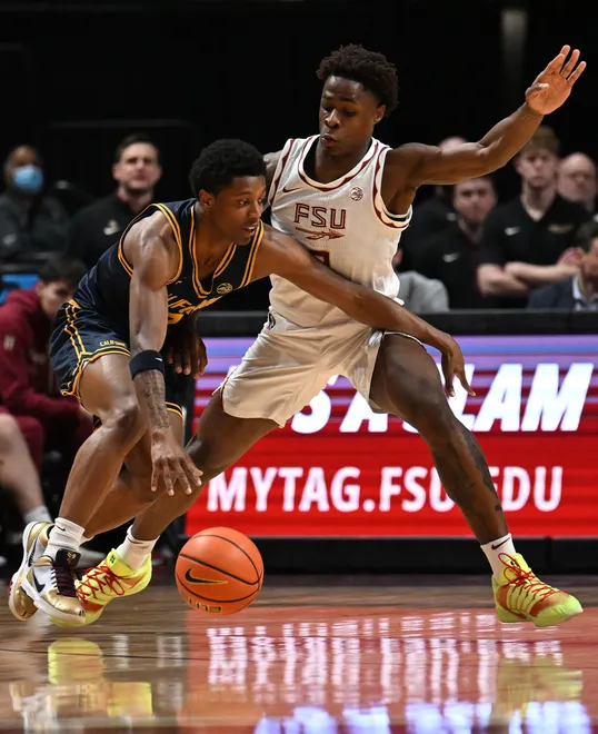 Jan 28, 2026; Tallahassee, Florida, USA; California Golden Bears Dai Dai Ames (7) drives to the net past Florida State Seminoles forward Thomas Bassong (3) during the first half at Donald L. Tucker Center. Mandatory Credit: Melina Myers-Imagn Images