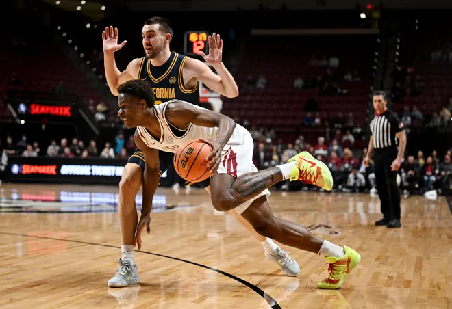 Jan 28, 2026; Tallahassee, Florida, USA; Florida State Seminoles forward Thomas Bassong (3) drives to the net past the defense of California Golden Bears forward John Camden (2) during the first half at Donald L. Tucker Center. Mandatory Credit: Melina Myers-Imagn Images