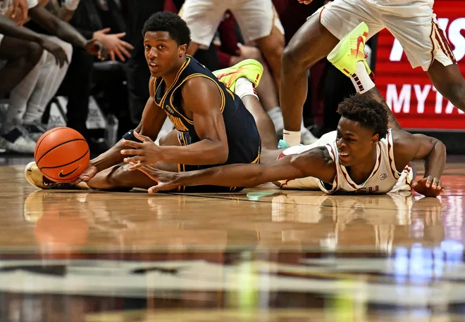 Jan 28, 2026; Tallahassee, Florida, USA; California Golden Bears Dai Dai Ames (7) fights for a loose ball against Florida State Seminoles forward Thomas Bassong (3) during the first half at Donald L. Tucker Center. Mandatory Credit: Melina Myers-Imagn Images