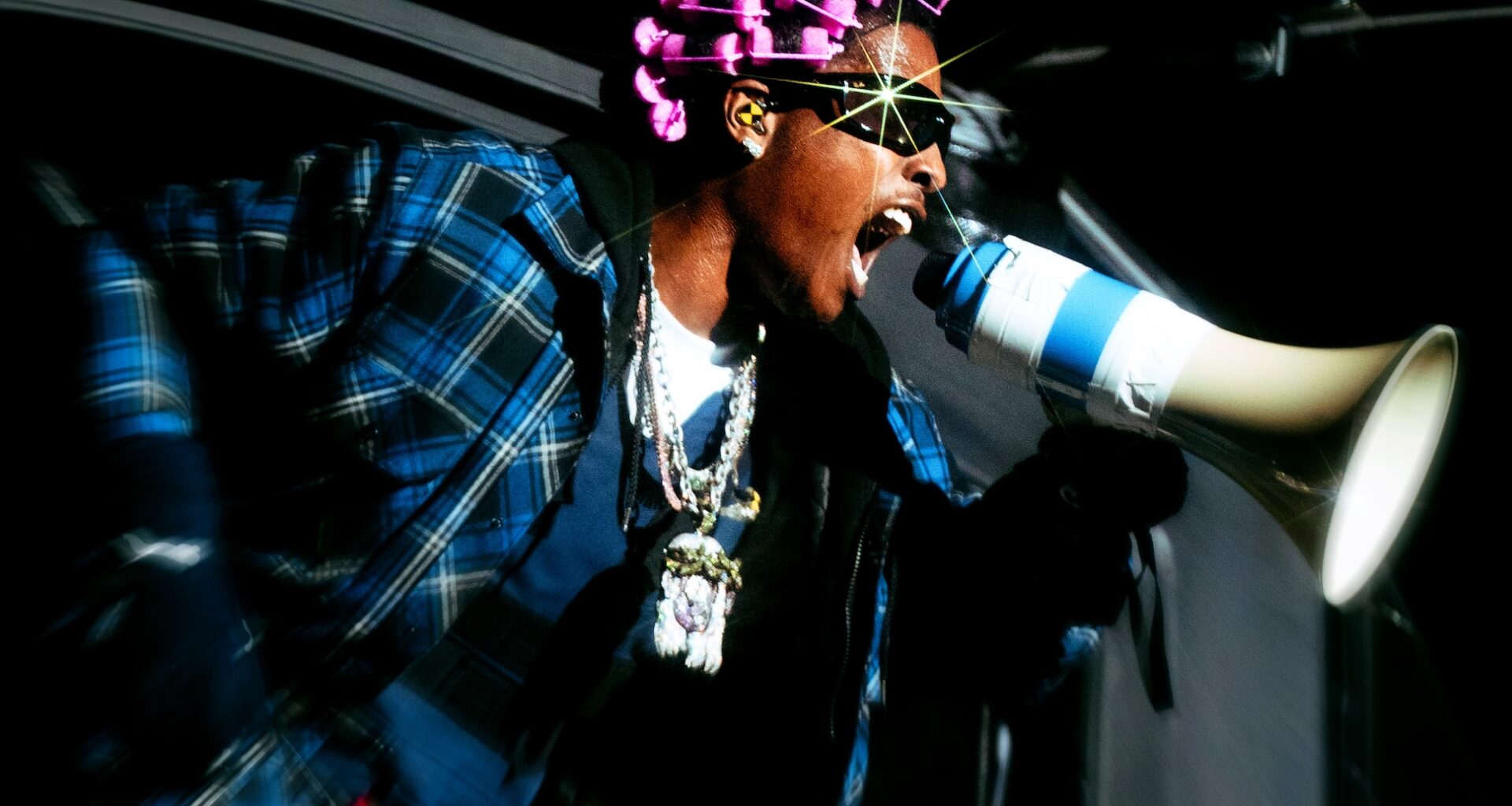 Photo of a man screaming at a megaphone