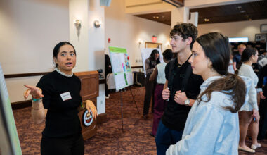 Emma Clark, a junior earning degrees in Political Science and Philosophy, discusses her project with attendees at the 2025 Global Scholars Showcase. (Brittany Mobley/Division of Undergraduate Studies)