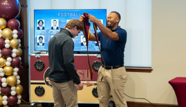 An FSU student-athlete is given their stole at a Student Athlete Academic Services graduation brunch.