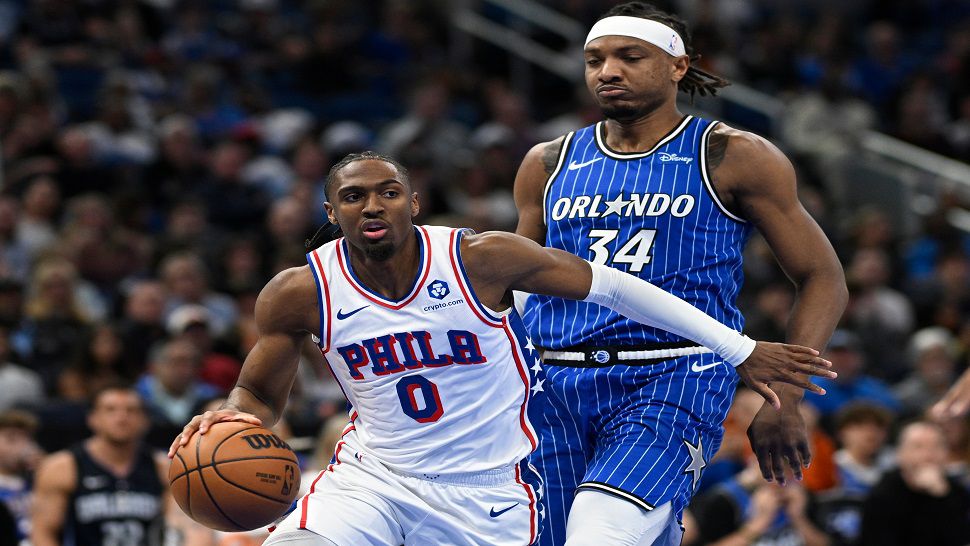 Philadelphia 76ers guard Tyrese Maxey (0) drives to the basket past Orlando Magic center Wendell Carter Jr. (34) during the first half of an NBA basketball game, Friday, Jan. 9, 2026, in Orlando, Fla. (AP Photo/Phelan M. Ebenhack)