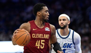 Cleveland Cavaliers guard Donovan Mitchell (45) drives to the basket as Orlando Magic guard Jalen Suggs (4) defends during the first half of an NBA basketball game, Saturday, Jan. 24, 2026, in Orlando, Fla. (AP Photo/Phelan M. Ebenhack)