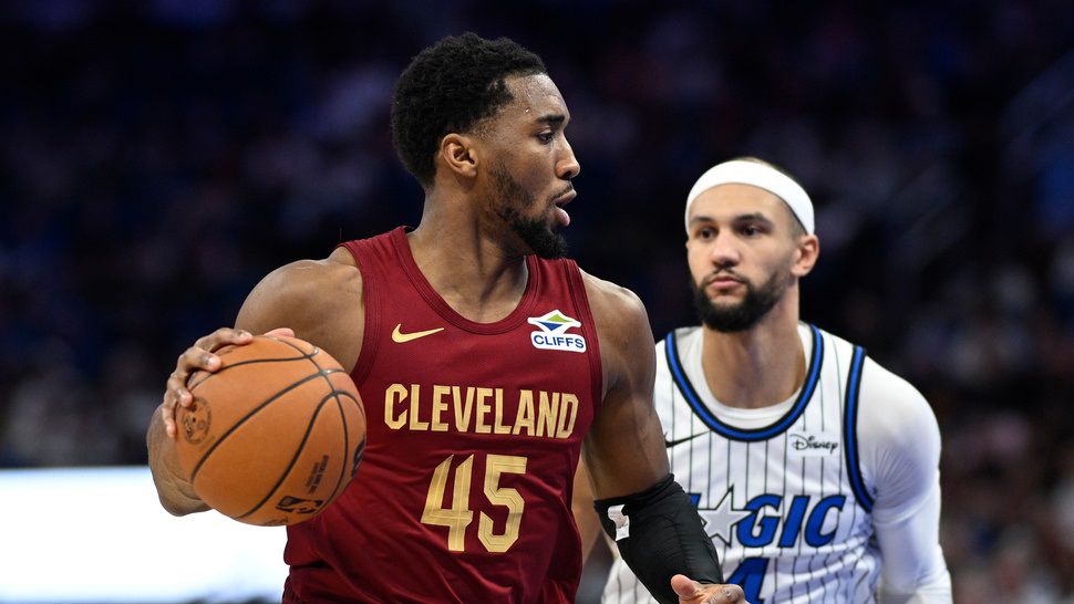 Cleveland Cavaliers guard Donovan Mitchell (45) drives to the basket as Orlando Magic guard Jalen Suggs (4) defends during the first half of an NBA basketball game, Saturday, Jan. 24, 2026, in Orlando, Fla. (AP Photo/Phelan M. Ebenhack)