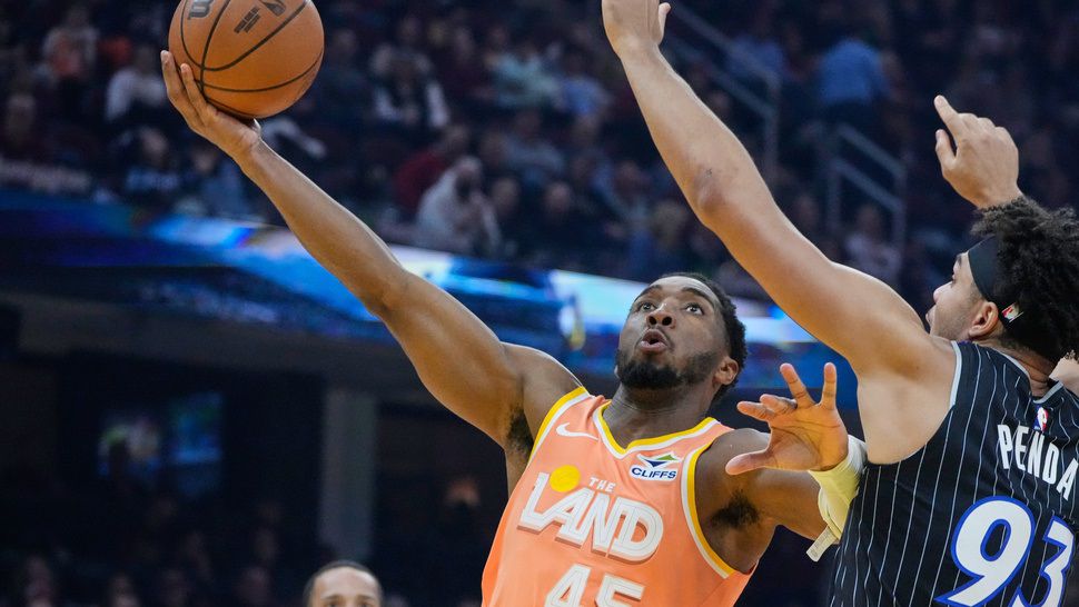 Cleveland Cavaliers guard Donovan Mitchell (45) goes to the basket past Orlando Magic forward Noah Penda (93) in the first half of an NBA basketball game in Cleveland, Monday, Jan. 26, 2026. (AP Photo/Sue Ogrocki)