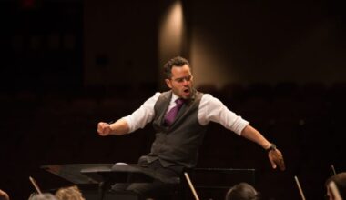 A conductor in front of an orchestra