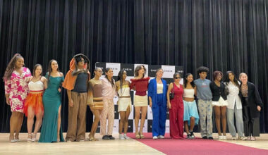 Photo of students standing on a stage in an auditorium