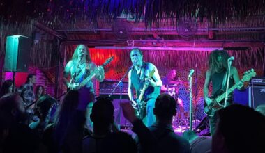 A rock band with guitars on stage in Miami