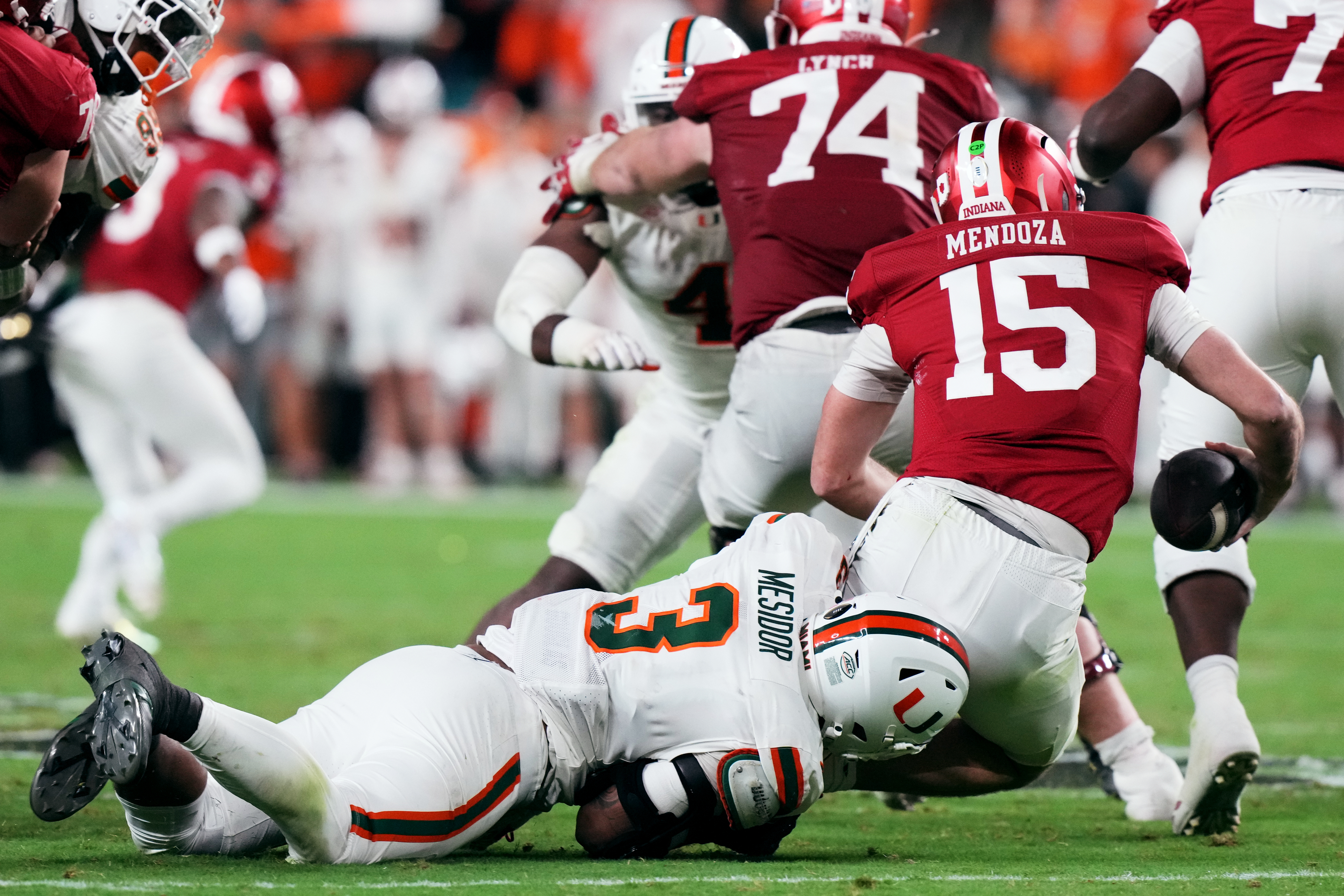 Indiana quarterback Fernando Mendoza is sacked by Miami defensive lineman Akheem Mesidor during the second half of the College Football Playoff national championship game, Monday, Jan. 19, 2026, in Miami Gardens, Fla. (AP Photo/Marta Lavandier)