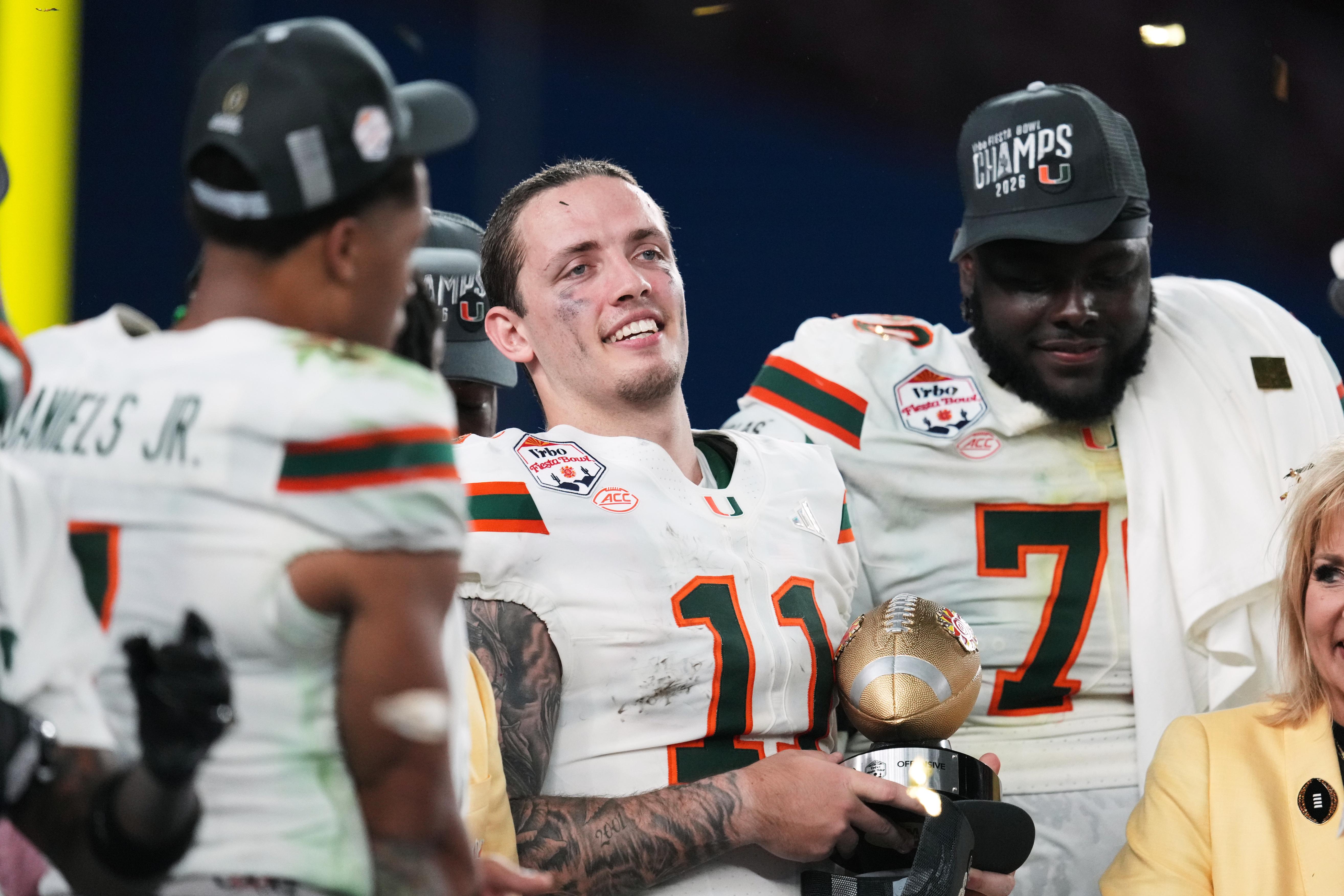 Miami quarterback Carson Beck (11) holds the offensive player of...