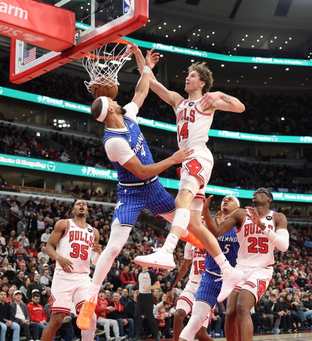 Bulls forward Matas Buzelis dunks over the defense of Magic guard Jalen Suggs in the second quarter at the United Center on Jan. 2, 2026, in Chicago. (John J. Kim/Chicago Tribune)
