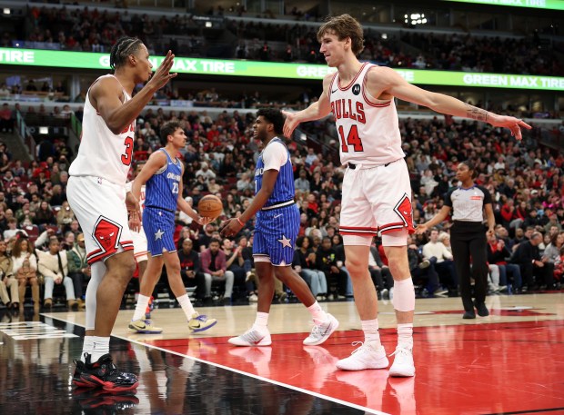 Bulls forward Isaac Okoro, left, is congratulated by Matas Buzelis (14) after drawing a foul on a basket in the second quarter at the United Center on Jan. 2, 2026, in Chicago. (John J. Kim/Chicago Tribune)