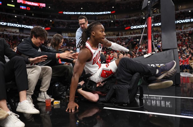 Bulls guard Ayo Dosunmu lands on a videographer during a rebound attempt in the first quarter against the Magic at the United Center on Jan. 2, 2026, in Chicago. (John J. Kim/Chicago Tribune)