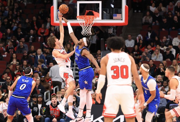 Bulls forward Matas Buzelis aims for the basket as Magic center Wendell Carter Jr. (34) defends in the third quarter at the United Center on Jan. 2, 2026, in Chicago. (John J. Kim/Chicago Tribune)