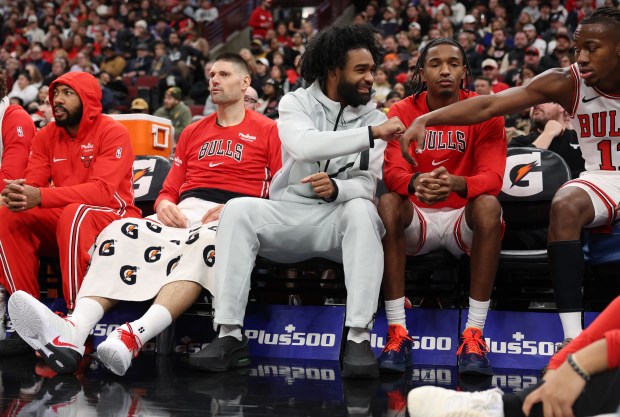 Bulls guard Coby White, center, fist bumps fellow guard Ayo Dosunmu in the third quarter against the Magic at the United Center on Jan. 2, 2026, in Chicago. (John J. Kim/Chicago Tribune)