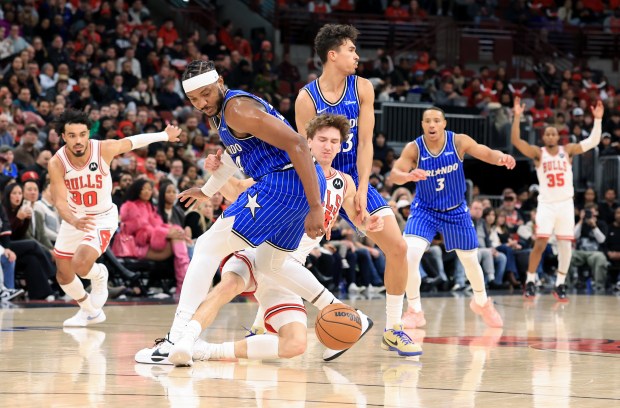 Bulls forward Matas Buzelis, center, is fouled by Magic center Wendell Carter Jr., center left, in the fourth quarter at the United Center on Jan. 2, 2026, in Chicago. (John J. Kim/Chicago Tribune)