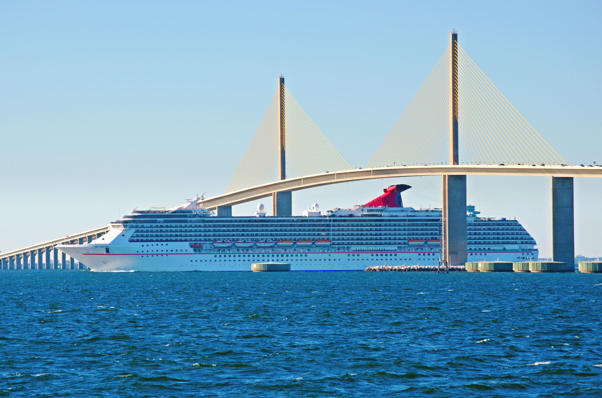 Carnival ship sailing under Tampa Sunshine Skyway Bridge
