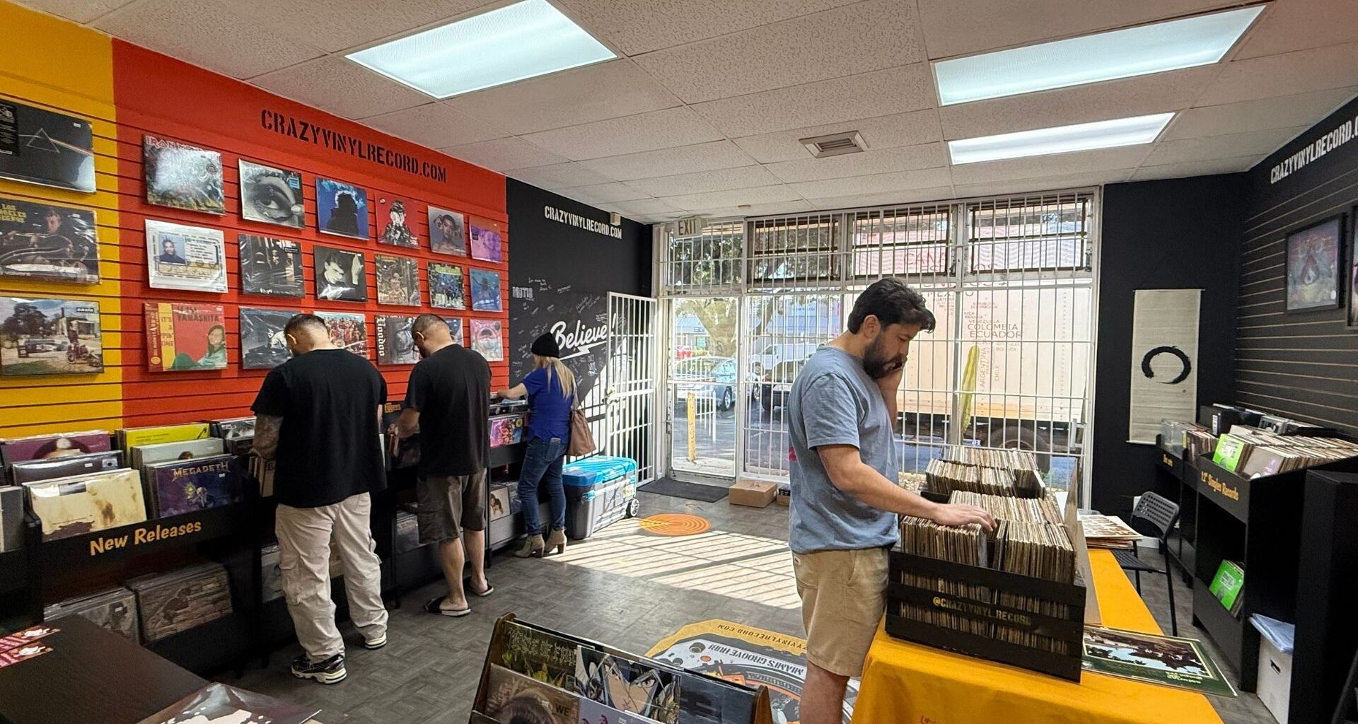 People at a store digging through vinyl