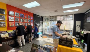 People at a store digging through vinyl