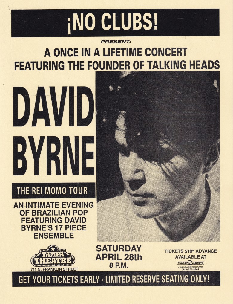 A vintage, cream-colored concert flyer for No Clubs Presents "A Once in a Lifetime Concert Featuring the Founder of Talking Heads, David Byrne." The right side of the flyer features a high-contrast, black-and-white close-up photograph of David Byrne looking downward.