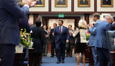Lawmakers applaud as Florida Gov. Ron DeSantis enters the house chamber to address a joint session, on the opening day of the 2025 legislative session, Tuesday, March 4, 2025, at the state capitol in Tallahassee, Fla. (AP Photo/Rebecca Blackwell)