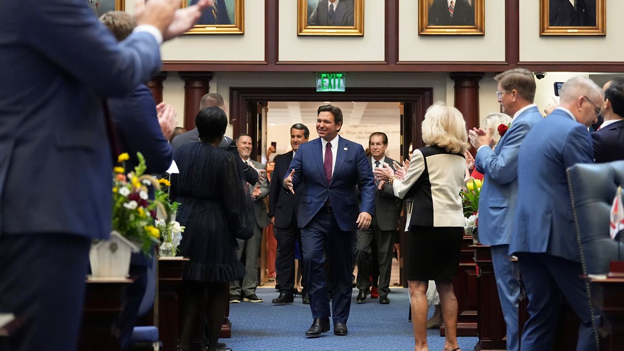 Lawmakers applaud as Florida Gov. Ron DeSantis enters the house chamber to address a joint session, on the opening day of the 2025 legislative session, Tuesday, March 4, 2025, at the state capitol in Tallahassee, Fla. (AP Photo/Rebecca Blackwell)
