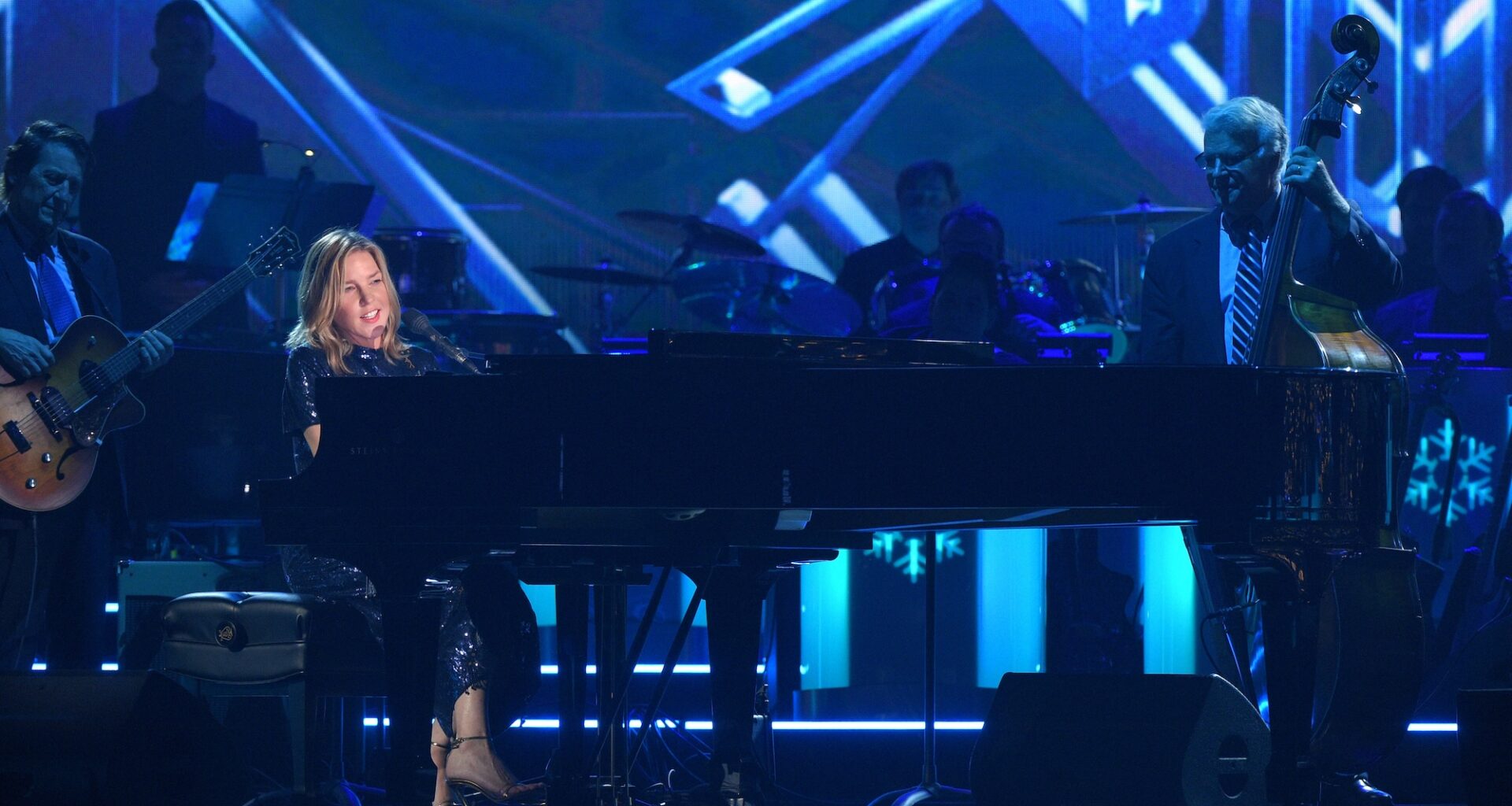 A woman playing piano on stage