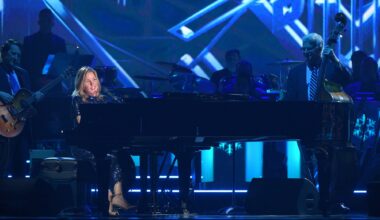 A woman playing piano on stage