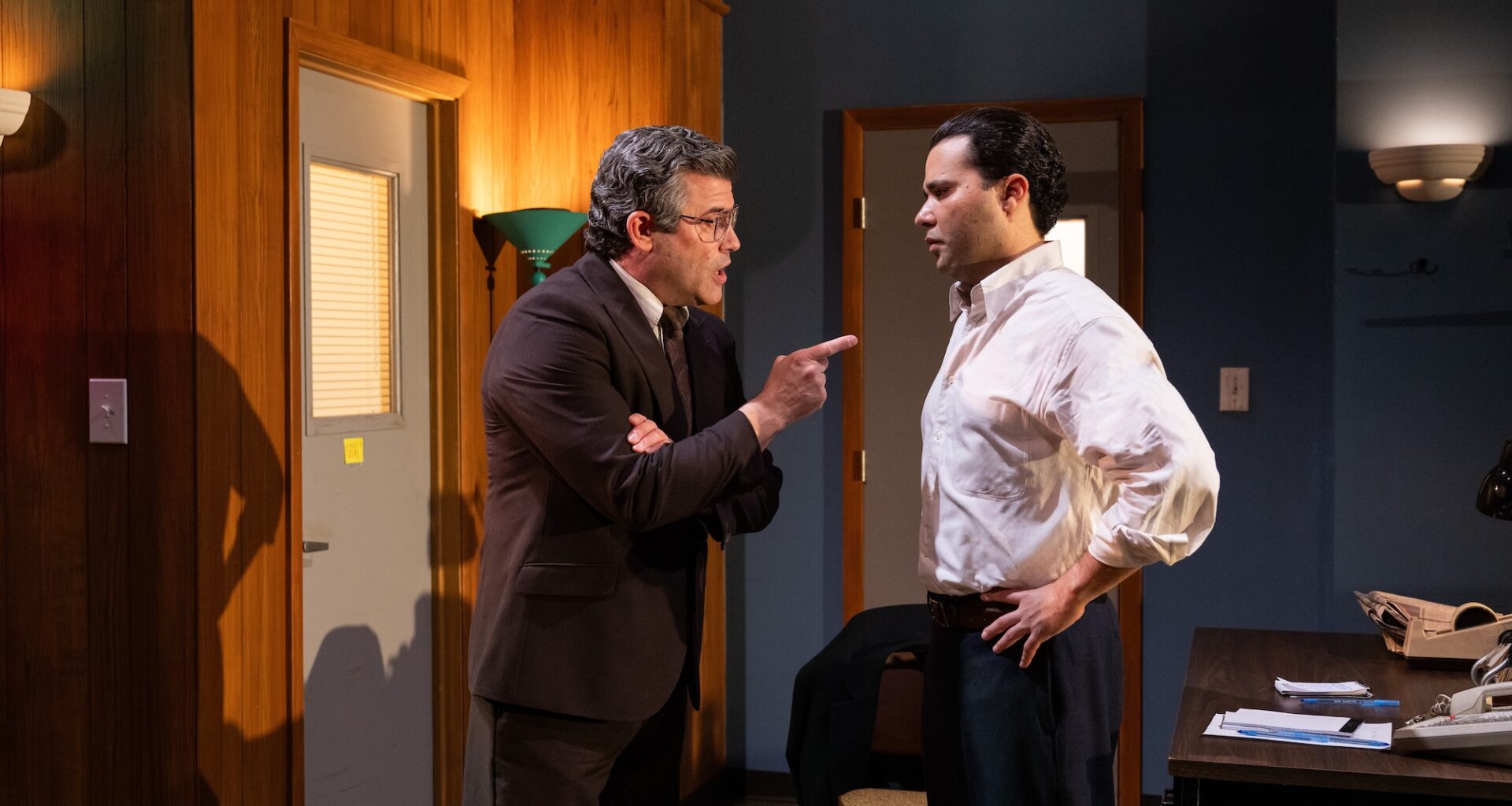 photo of two theater actors performing onstage