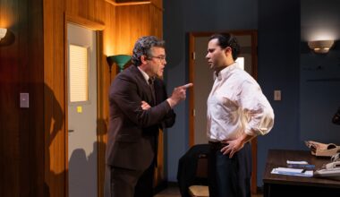 photo of two theater actors performing onstage