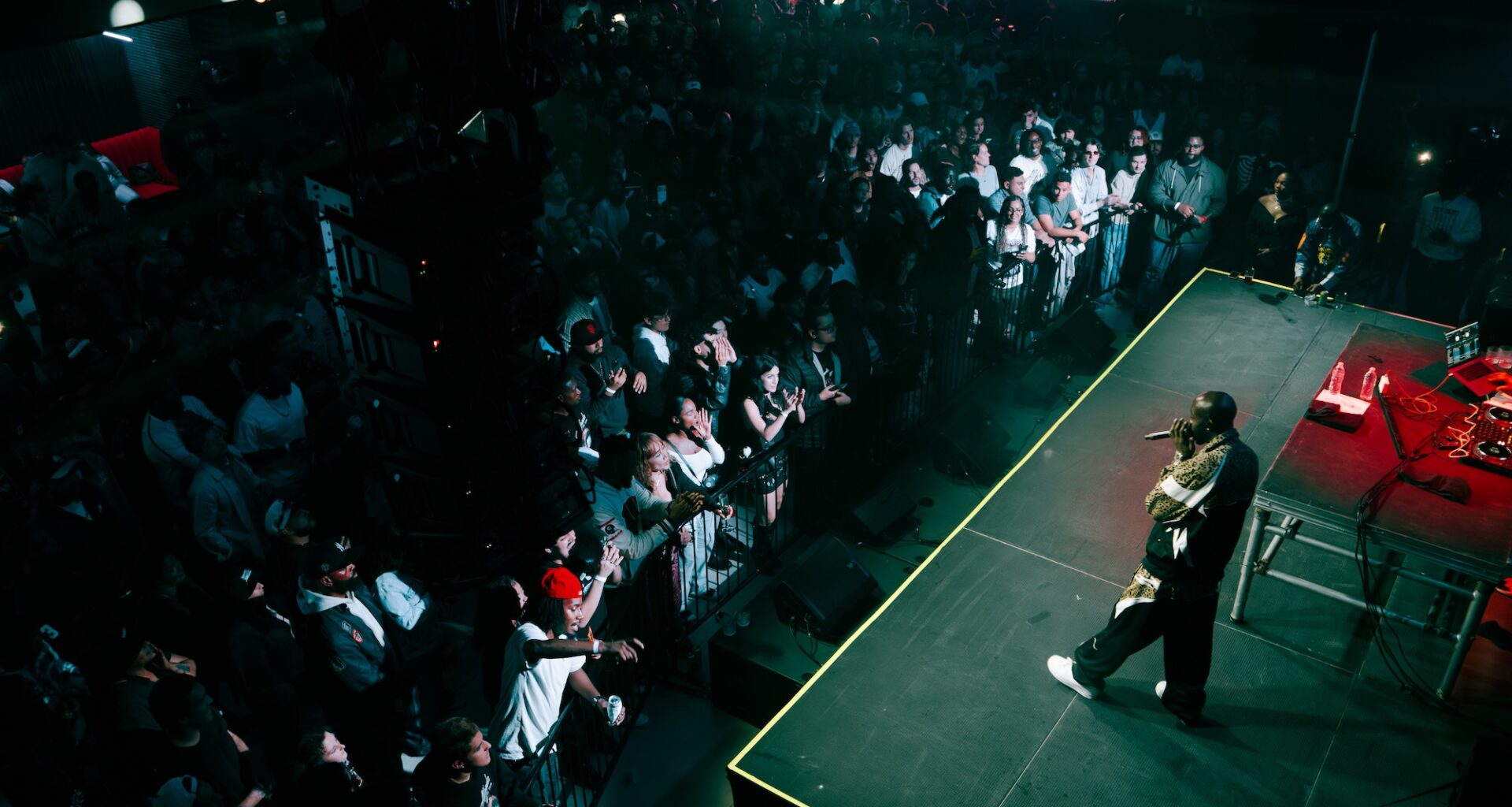 A man singing on stage in front of a crowd.