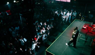 A man singing on stage in front of a crowd.