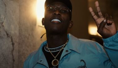 Portrait of a man doing the peace sign with his fingers.