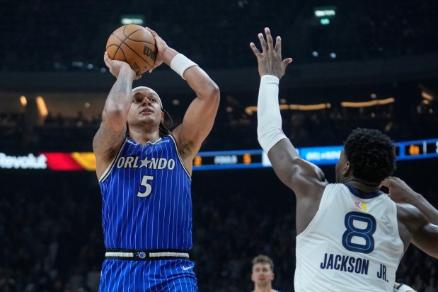 Orlando Magic forward Paolo Banchero (5) shoots during an NBA basketball game between Orlando Magic and Memphis Grizzlies in Berlin, Germany, Thursday, Jan. 15, 2026. (AP Photo/Ebrahim Noroozi)
