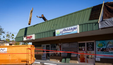 A construction worker discards debris from the roof of a restaurant damaged during a storm ahead of Hurricane Milton’s landfall on Oct. 14, 2024, in Fort Myers, Fla. Credit: Eva Marie Uzcategui/The Washington Post via Getty Images