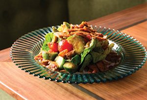 Greek salad with tomatoes, cucumbers, and ripped pita. Photo by Salar Abduaziz