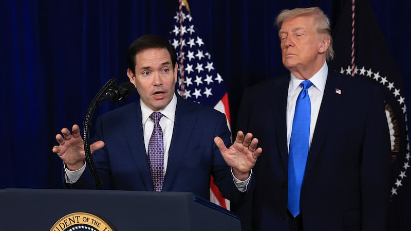 PALM BEACH, FLORIDA - JANUARY 03: Secretary of State Marco Rubio speaks during a press conference as Homeland Security Advisor Stephen Miller and U.S. President Donald Trump listen at Mar-a-Lago club on January 03, 2026, in Palm Beach, Florida. During the event, President Trump confirmed that the United States military carried out a large-scale strike in Caracas overnight, resulting in the capture of Venezuelan leader Nicolás Maduro and his wife, Cilia Flores.  (Photo by Joe Raedle/Getty Images)